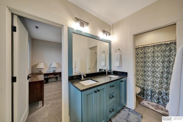 bathroom with vanity, walk in shower, and toilet