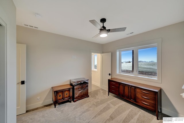misc room with ceiling fan and light colored carpet