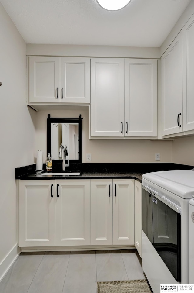 kitchen with white cabinetry, range, light tile patterned flooring, and sink