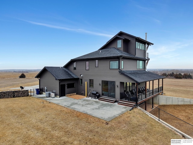 back of property featuring a yard, a patio area, and central air condition unit