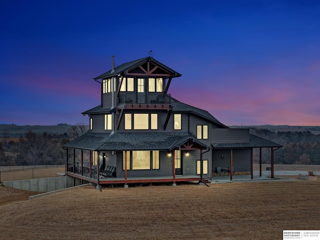 view of front facade featuring a sunroom and a patio area