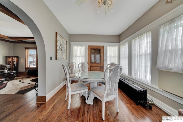 dining room featuring beamed ceiling and hardwood / wood-style floors