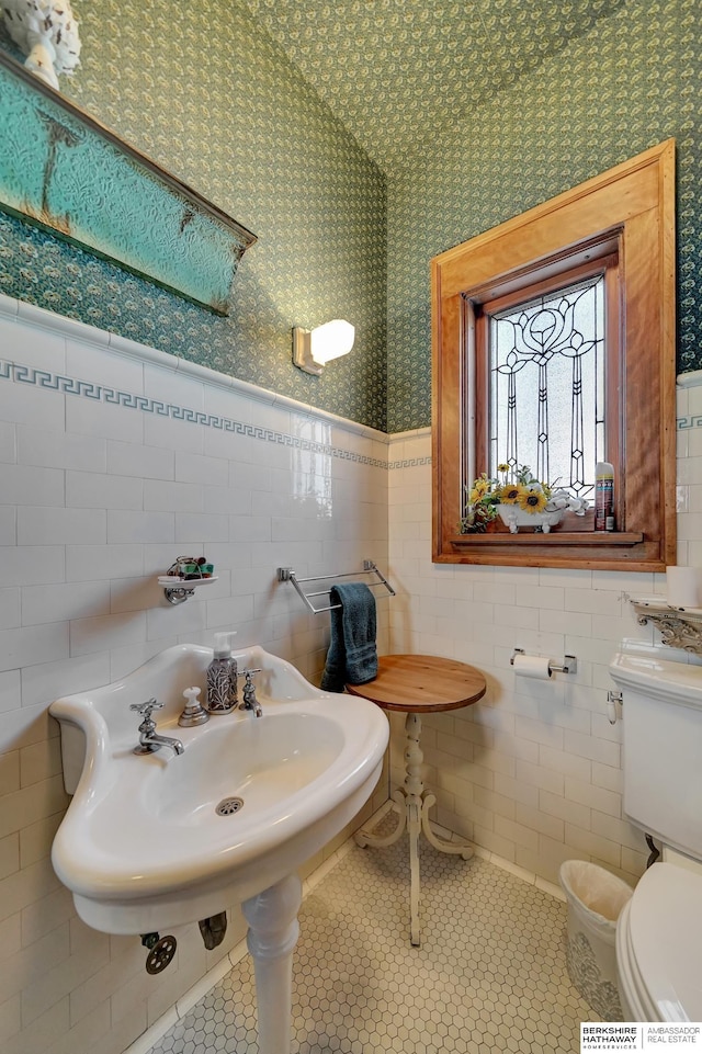 bathroom featuring tile walls, sink, tile patterned floors, and toilet