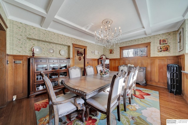 dining space featuring coffered ceiling, beam ceiling, light hardwood / wood-style flooring, and a notable chandelier