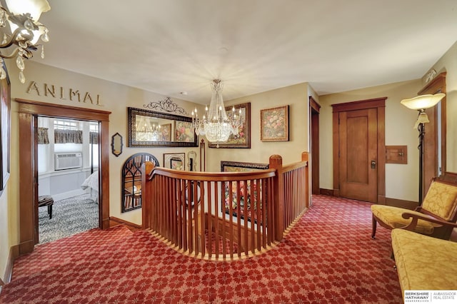 corridor with cooling unit, a chandelier, and carpet flooring