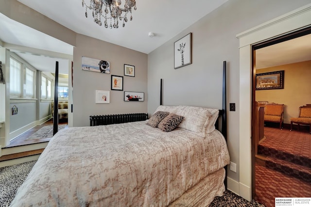 carpeted bedroom featuring an inviting chandelier and radiator heating unit