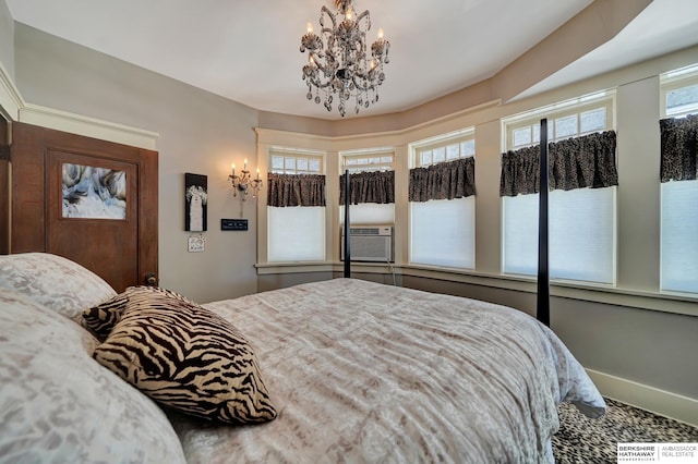 bedroom with cooling unit and a chandelier