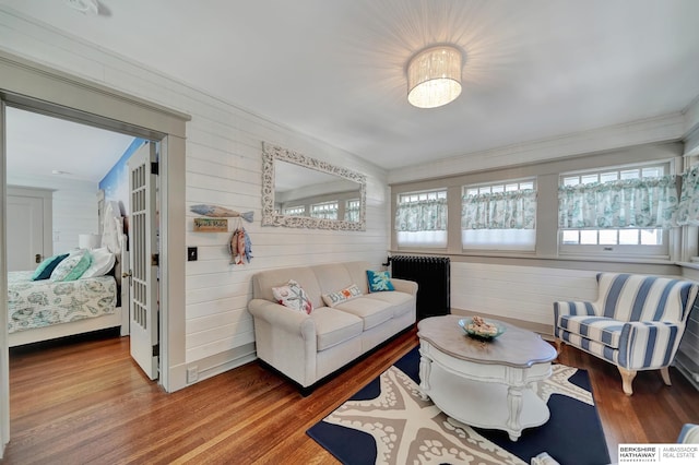 living room with crown molding, radiator, and hardwood / wood-style floors