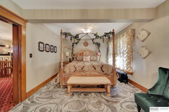 carpeted bedroom featuring a chandelier