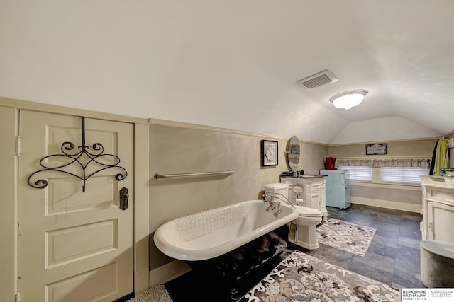 bathroom featuring lofted ceiling, sink, and a bathtub