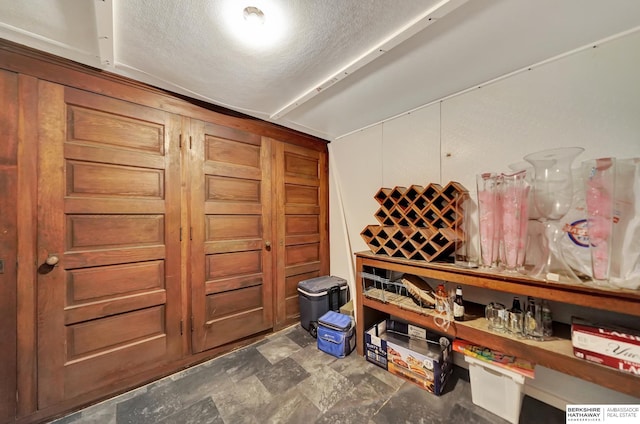 wine room featuring a textured ceiling