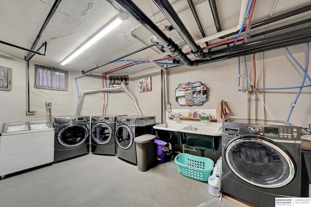 clothes washing area featuring sink and washer and clothes dryer