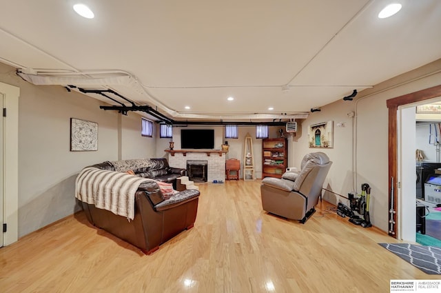 living room featuring wood-type flooring and a fireplace