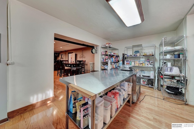 kitchen with light hardwood / wood-style floors and stainless steel counters