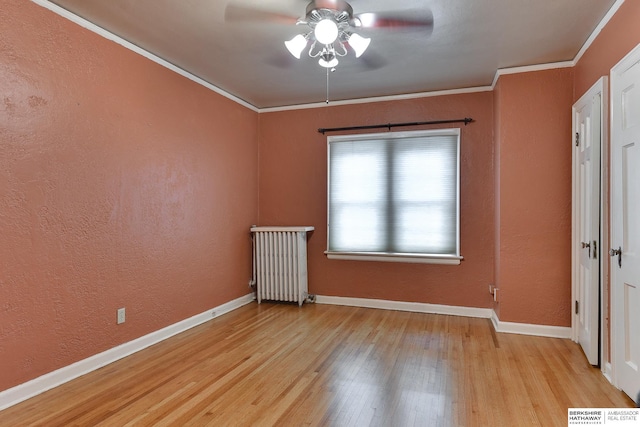 unfurnished bedroom featuring crown molding, light wood-type flooring, radiator heating unit, and ceiling fan