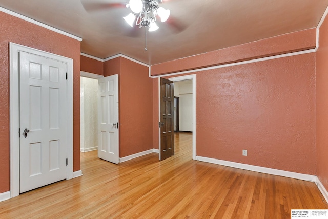 unfurnished bedroom featuring ornamental molding, light hardwood / wood-style floors, and ceiling fan