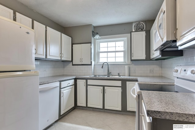 kitchen with sink, white appliances, a textured ceiling, white cabinets, and decorative backsplash