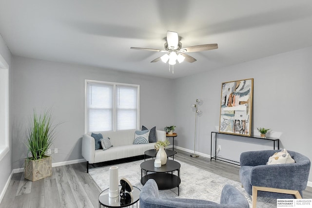 living room featuring ceiling fan and light hardwood / wood-style floors