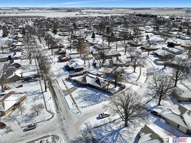 snowy aerial view with a residential view