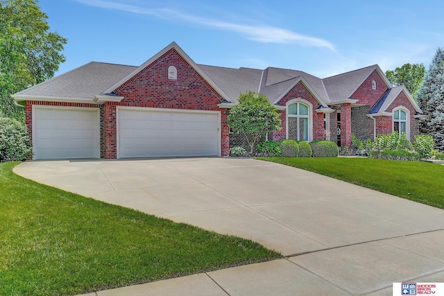 view of front of property with a garage and a front lawn