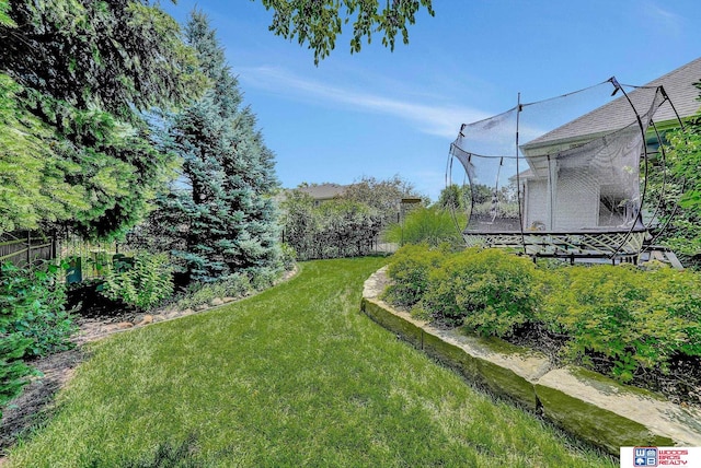 view of yard with a trampoline