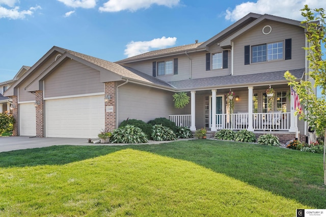 view of front of home featuring a garage, a front yard, and covered porch