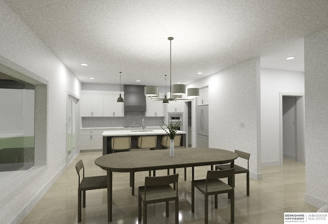 dining area with sink and a textured ceiling