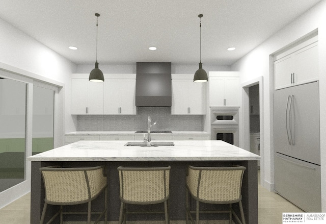 kitchen featuring white cabinetry, wall chimney exhaust hood, stainless steel appliances, and an island with sink