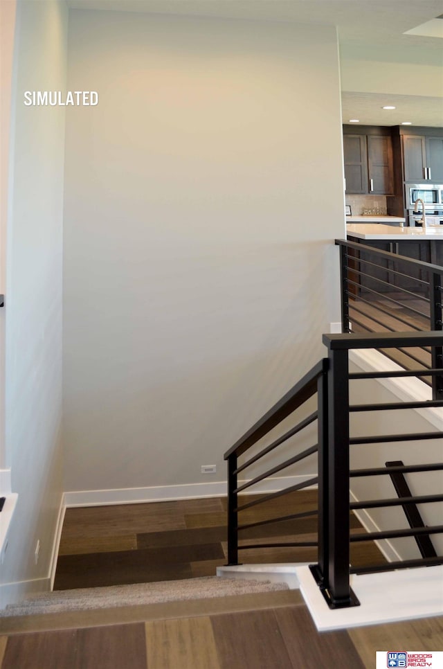 stairs featuring hardwood / wood-style floors