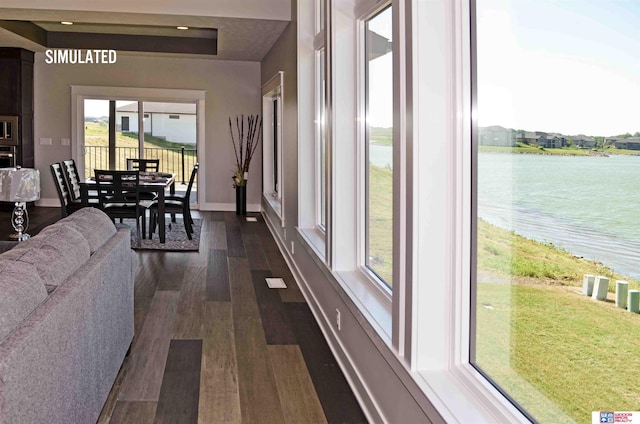 hall featuring dark wood-type flooring and a water view