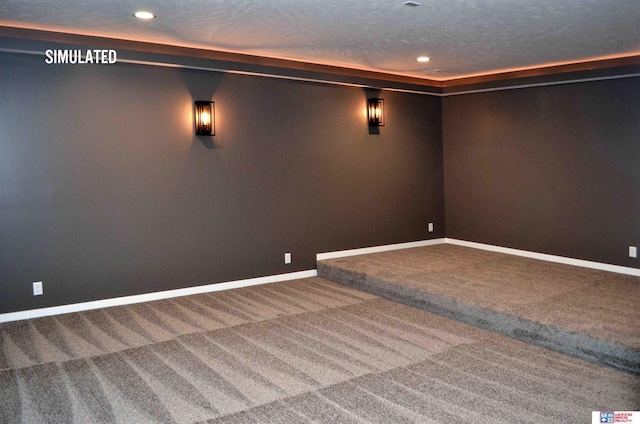 cinema featuring carpet floors and a textured ceiling