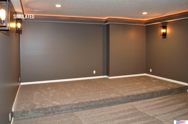 carpeted home theater room featuring a textured ceiling