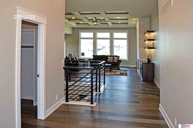 hallway featuring coffered ceiling, dark wood-type flooring, and beam ceiling