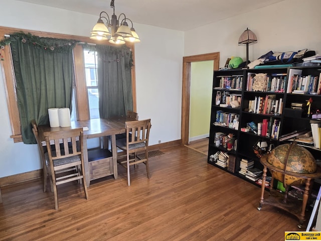 dining area with an inviting chandelier and hardwood / wood-style floors