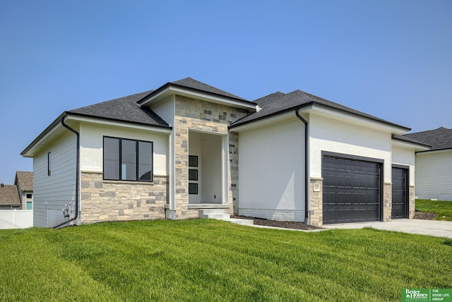 prairie-style home featuring a garage and a front lawn