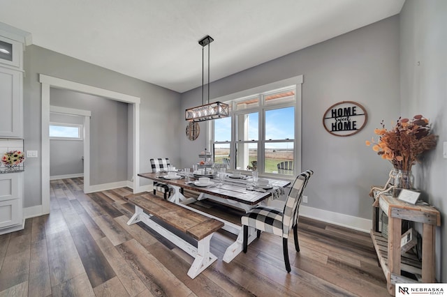 dining room featuring dark hardwood / wood-style flooring, a chandelier, and a wealth of natural light