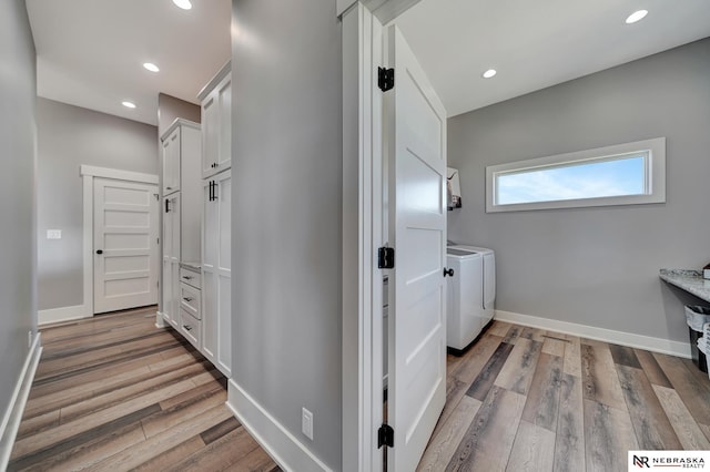 washroom with independent washer and dryer and hardwood / wood-style floors