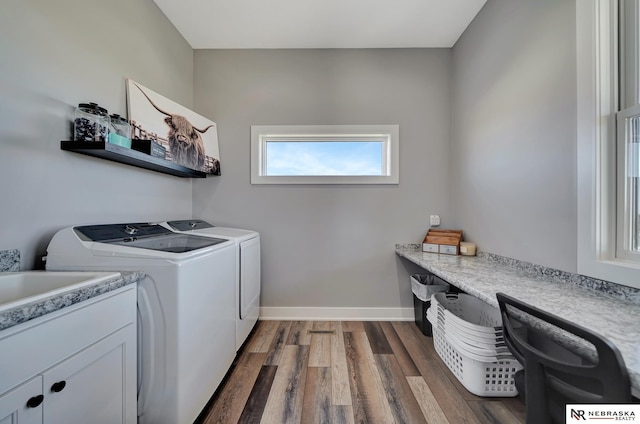 laundry room with dark hardwood / wood-style flooring and washer and dryer