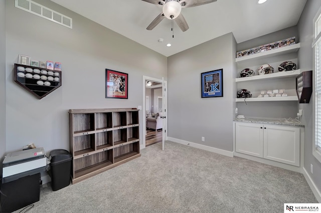 misc room featuring light carpet and ceiling fan