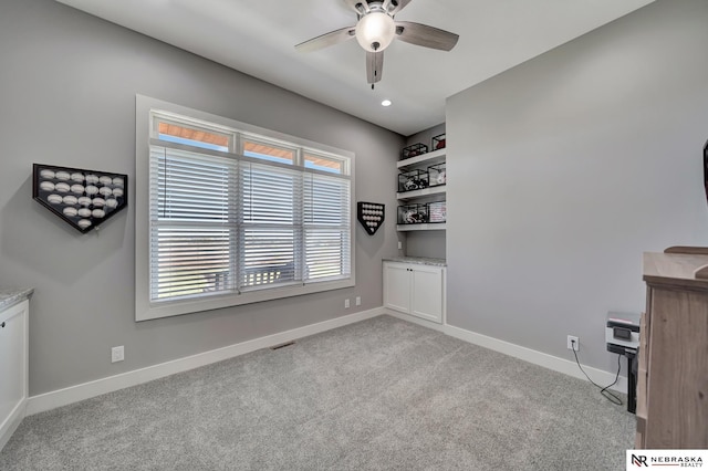 interior space featuring ceiling fan and light carpet