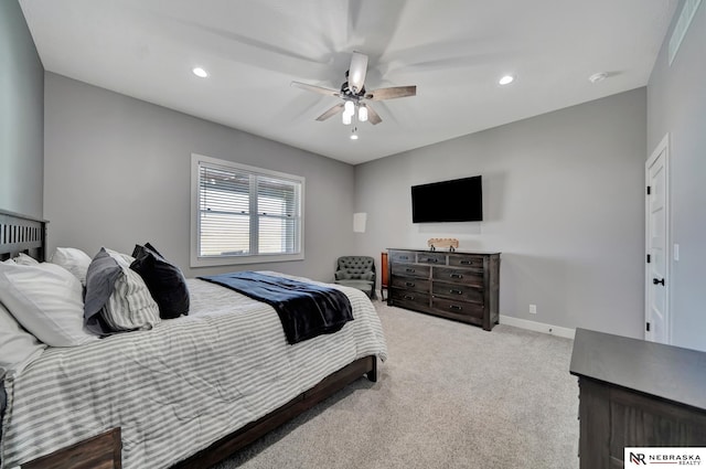 bedroom with ceiling fan and light colored carpet