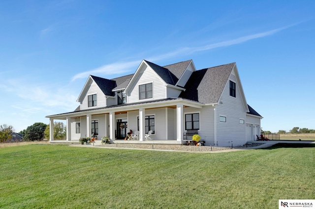 view of front of home with a garage, covered porch, and a front lawn