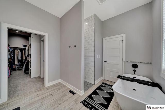 bathroom featuring shower with separate bathtub