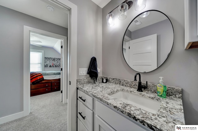 bathroom with vanity and vaulted ceiling