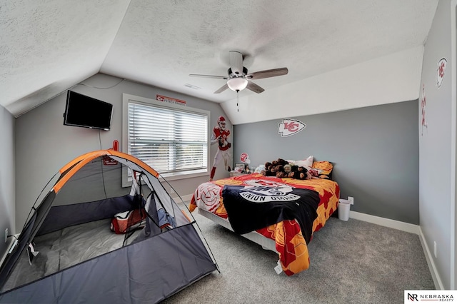 carpeted bedroom with lofted ceiling, a textured ceiling, and ceiling fan