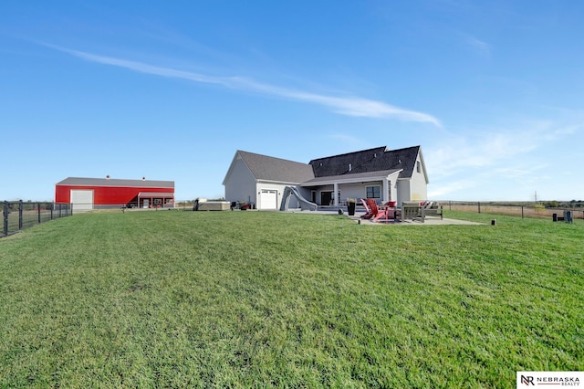 view of yard featuring a garage and a patio