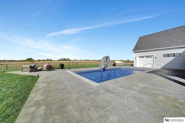 view of pool with an outdoor living space, a water slide, a yard, and a patio area