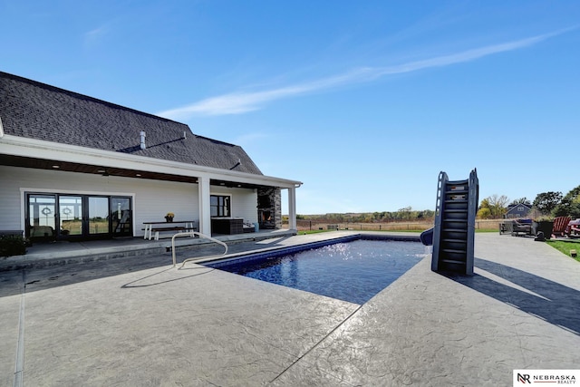 view of swimming pool featuring a patio area