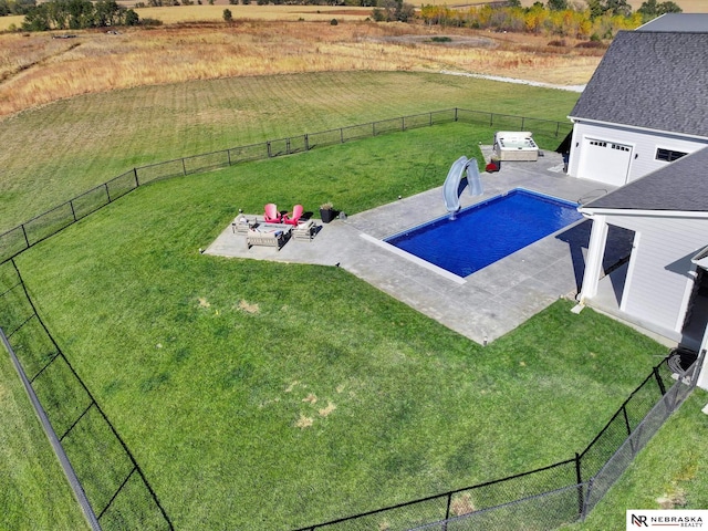 view of pool featuring a rural view, a yard, a patio, and a water slide