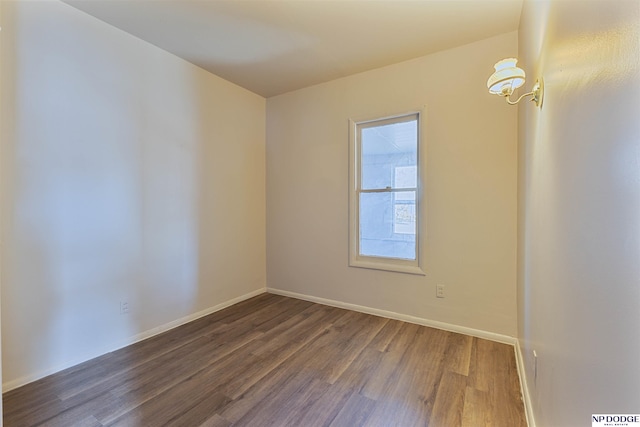 spare room featuring dark hardwood / wood-style floors